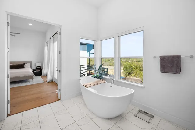 a view of roof deck with two chairs and potted plants