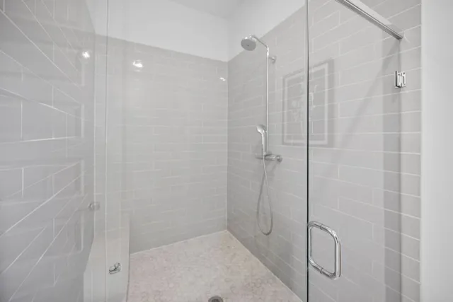 a bathroom with a tub sink and mirror