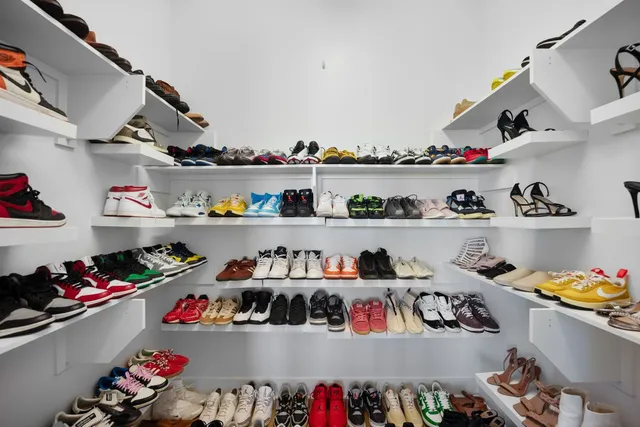 a view of walk in closet with clothes