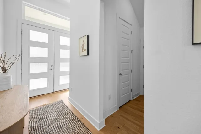 a view of a room with wooden floor and windows