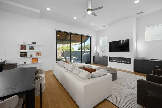 a kitchen with a refrigerator a sink dishwasher a stove and a flat screen tv