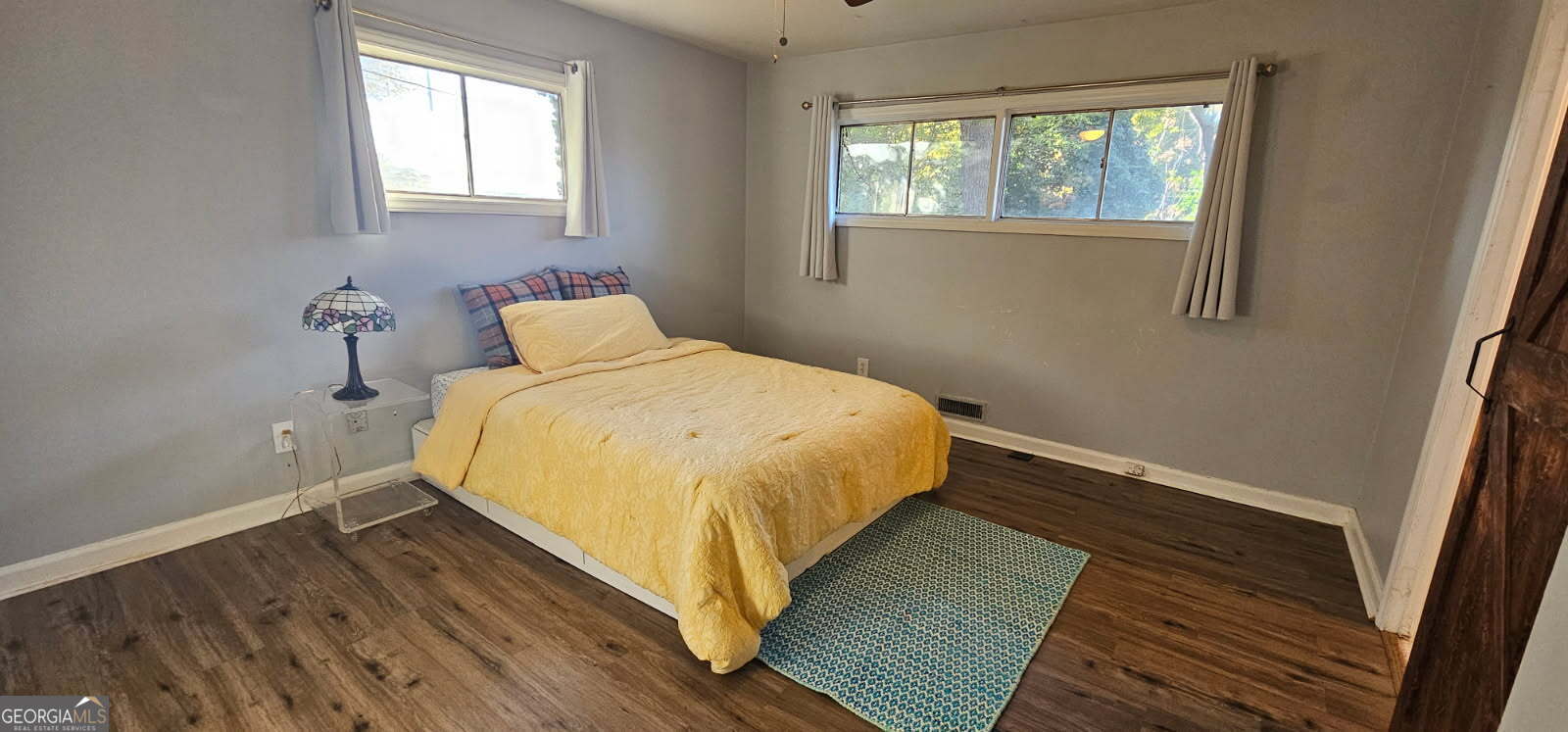 1976 Columbia Drive Decatur, GA 30032 - Photo 5 of 11 a bedroom with a bed and wooden floor