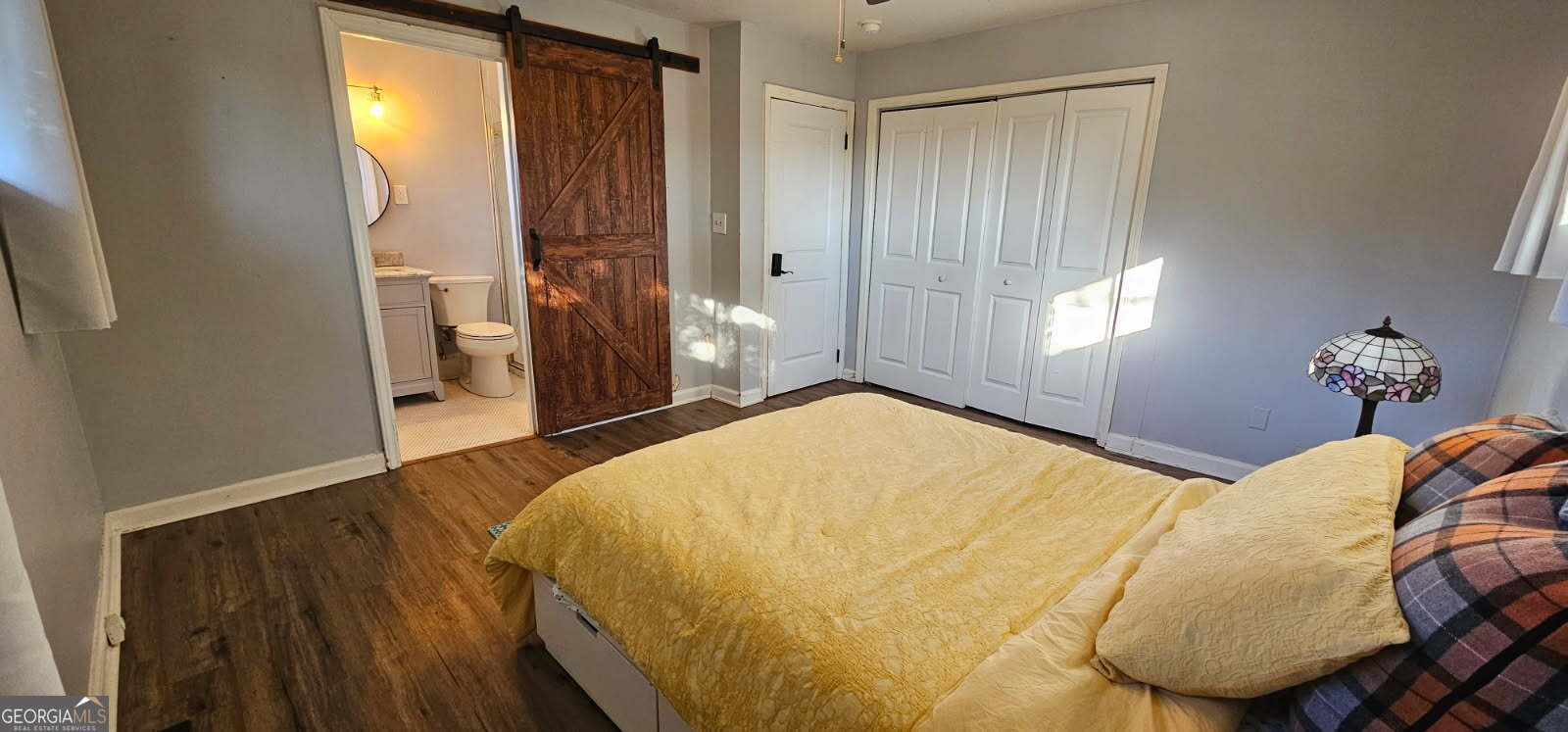 1976 Columbia Drive Decatur, GA 30032 - Photo 6 of 11 a bedroom with a bed and wooden floor