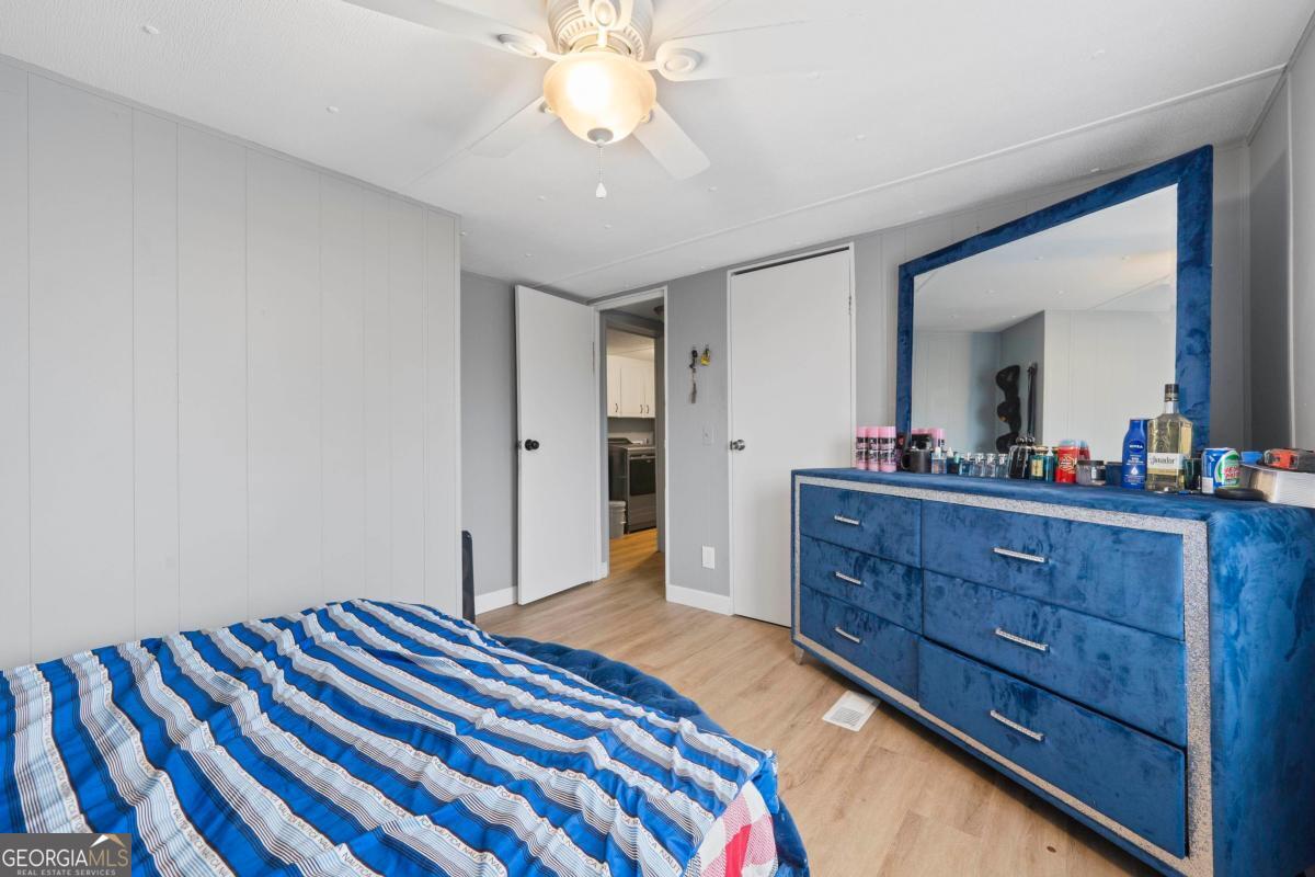 158 Thomas Field Road Southeast Milledgeville, GA 31061 - Photo 16 of 28 a bedroom with a bed and a dresser