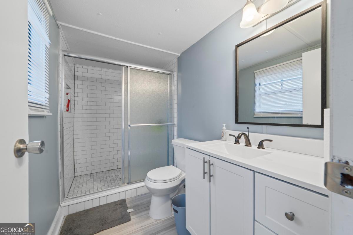 158 Thomas Field Road Southeast Milledgeville, GA 31061 - Photo 17 of 28 a bathroom with a sink a toilet and shower