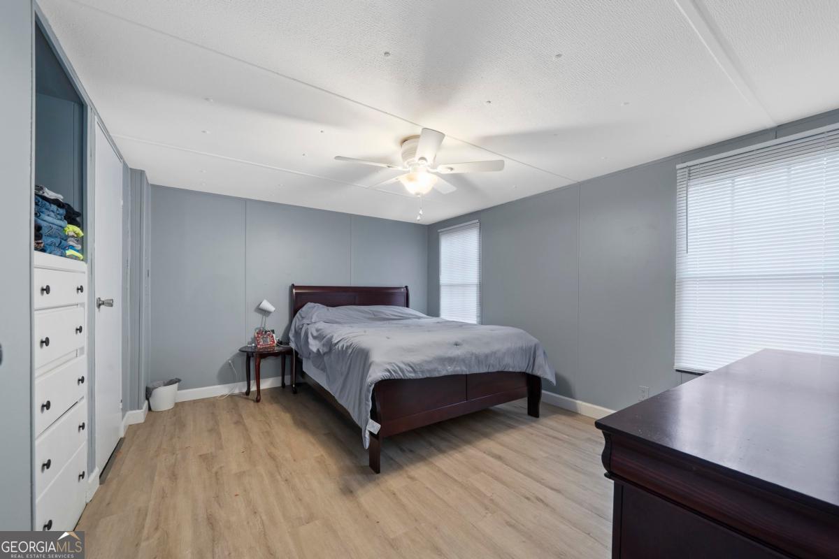 158 Thomas Field Road Southeast Milledgeville, GA 31061 - Photo 18 of 28 a bedroom with a bed and a table in it