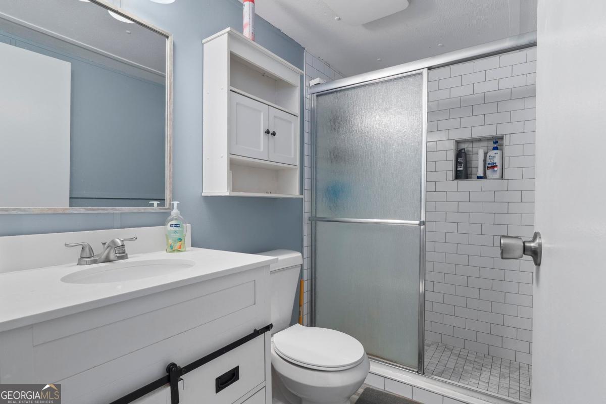 158 Thomas Field Road Southeast Milledgeville, GA 31061 - Photo 21 of 28 a bathroom with a sink toilet and shower