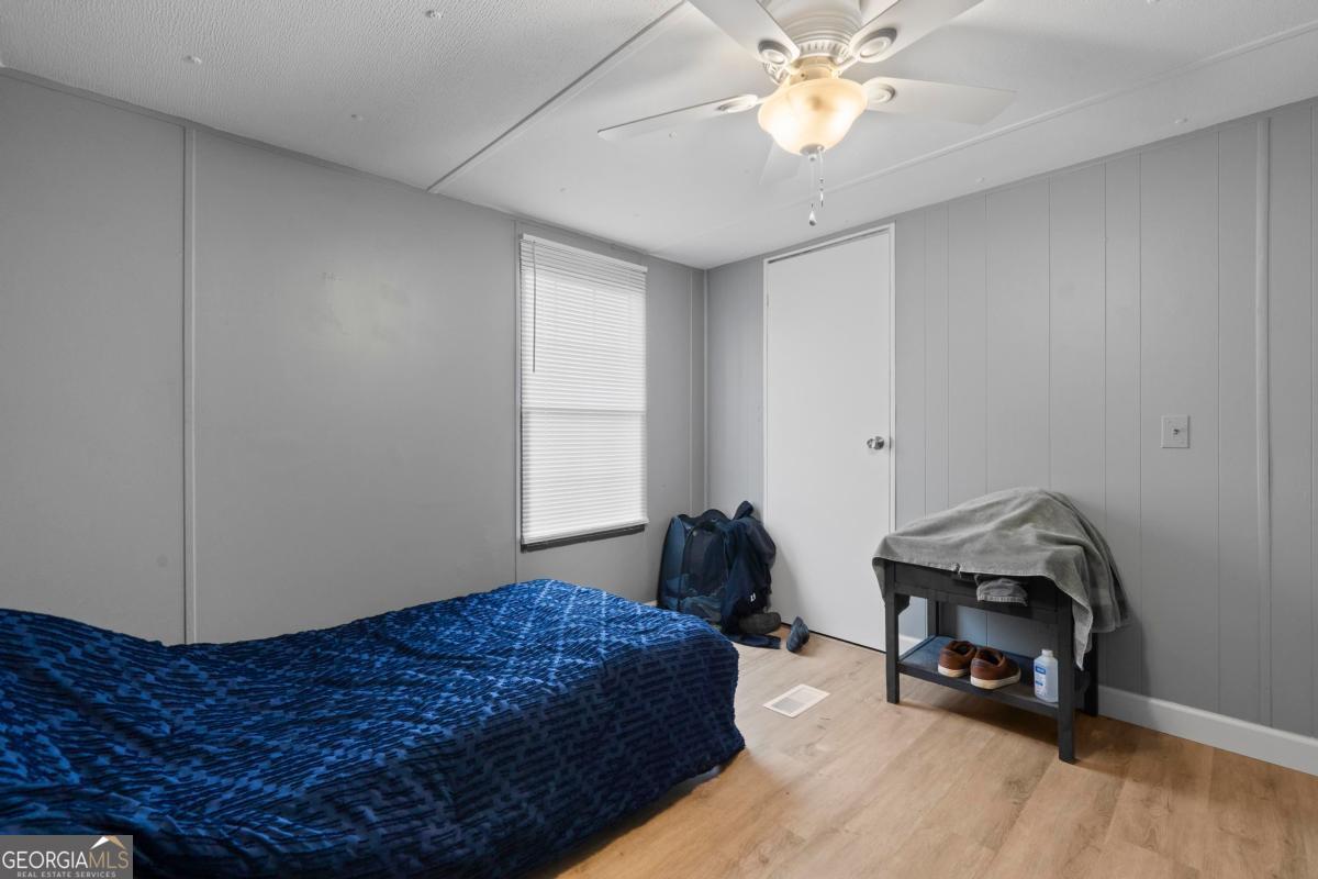 158 Thomas Field Road Southeast Milledgeville, GA 31061 - Photo 23 of 28 a bedroom with a bed and a chandelier