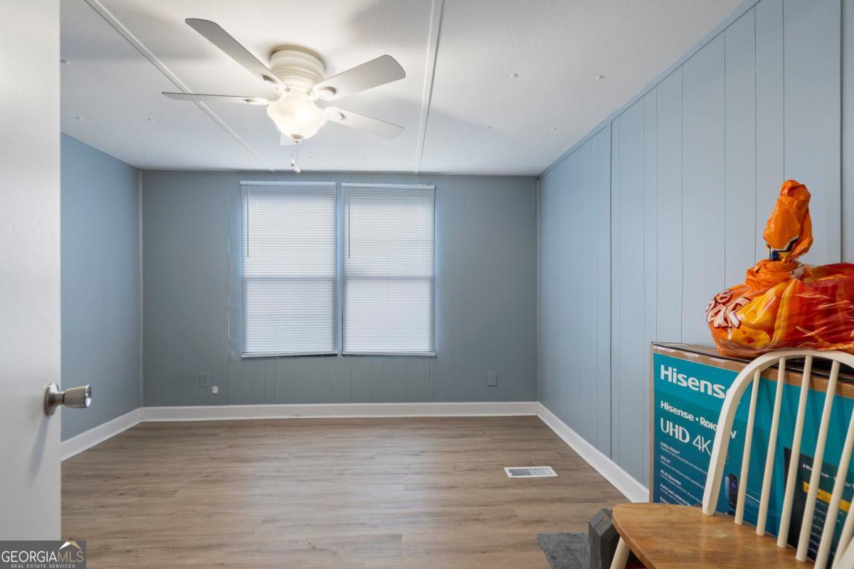 158 Thomas Field Road Southeast Milledgeville, GA 31061 - Photo 25 of 28 an empty room with windows and fan