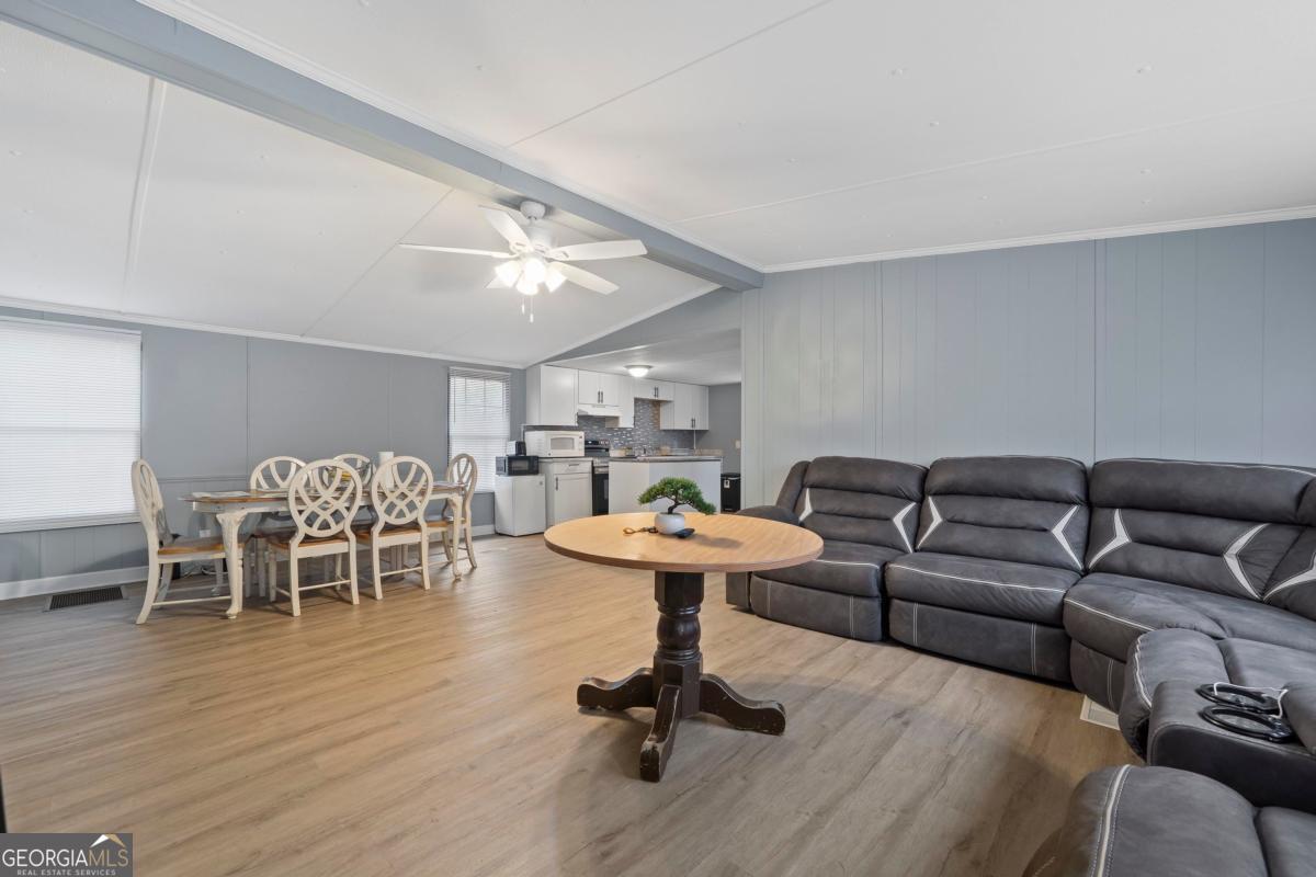 158 Thomas Field Road Southeast Milledgeville, GA 31061 - Photo 4 of 28 a living room with furniture and a wooden floor
