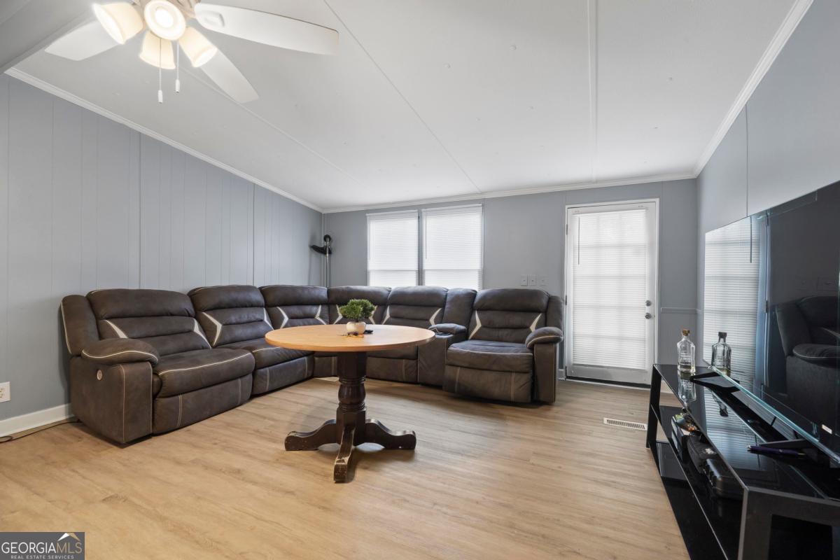158 Thomas Field Road Southeast Milledgeville, GA 31061 - Photo 5 of 28 a living room with furniture and a flat screen tv