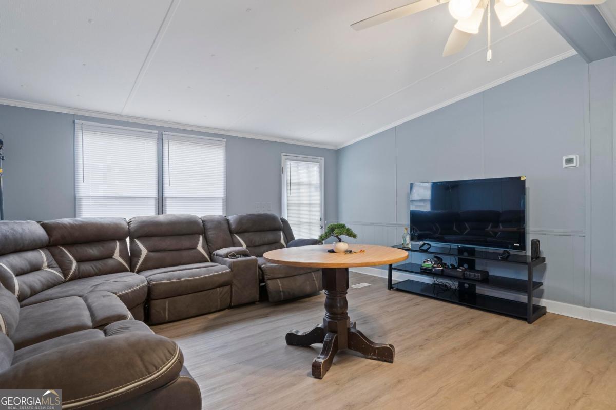 158 Thomas Field Road Southeast Milledgeville, GA 31061 - Photo 6 of 28 a living room with furniture and a flat screen tv