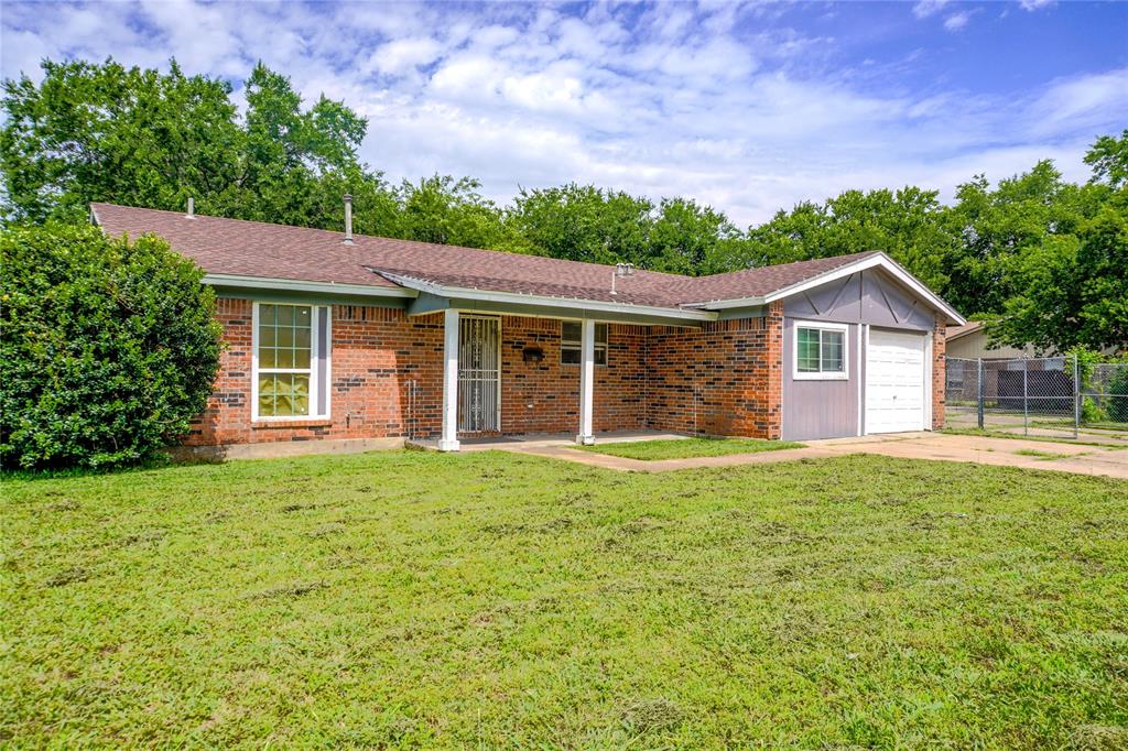 300 Coury Road Everman, TX 76140 - Photo 1 of 29 a front view of a house with a garden