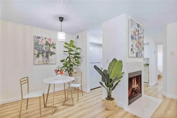 a view of a building with garden and sitting area
