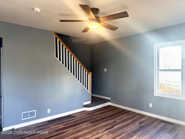 a view of a room with wooden floor