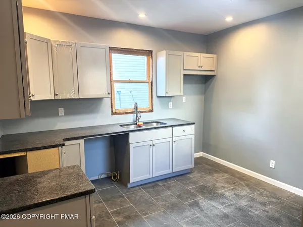 a kitchen with a sink cabinets and window
