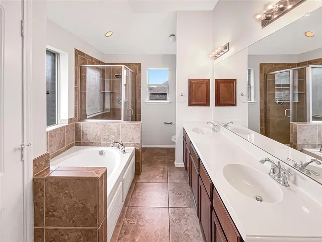 a bathroom with a tub sink and mirror