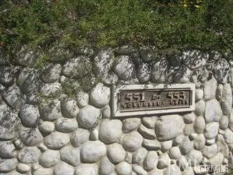 a sign broad in front of the tree