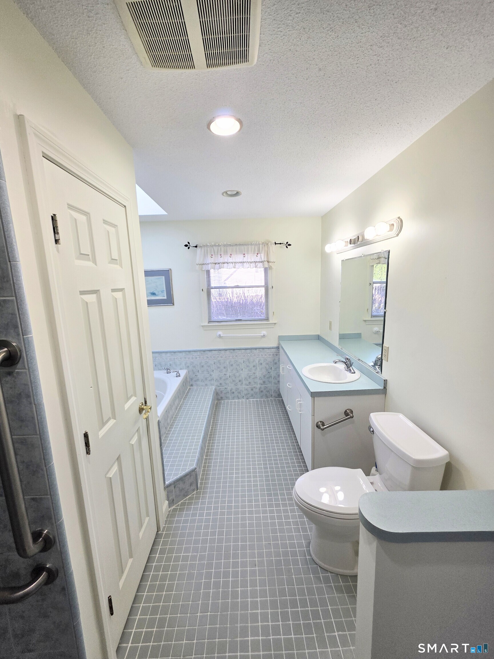 44 Steele Street New Britain, CT 06052 - Photo 15 of 27 a bathroom with a sink a toilet a mirror and shower