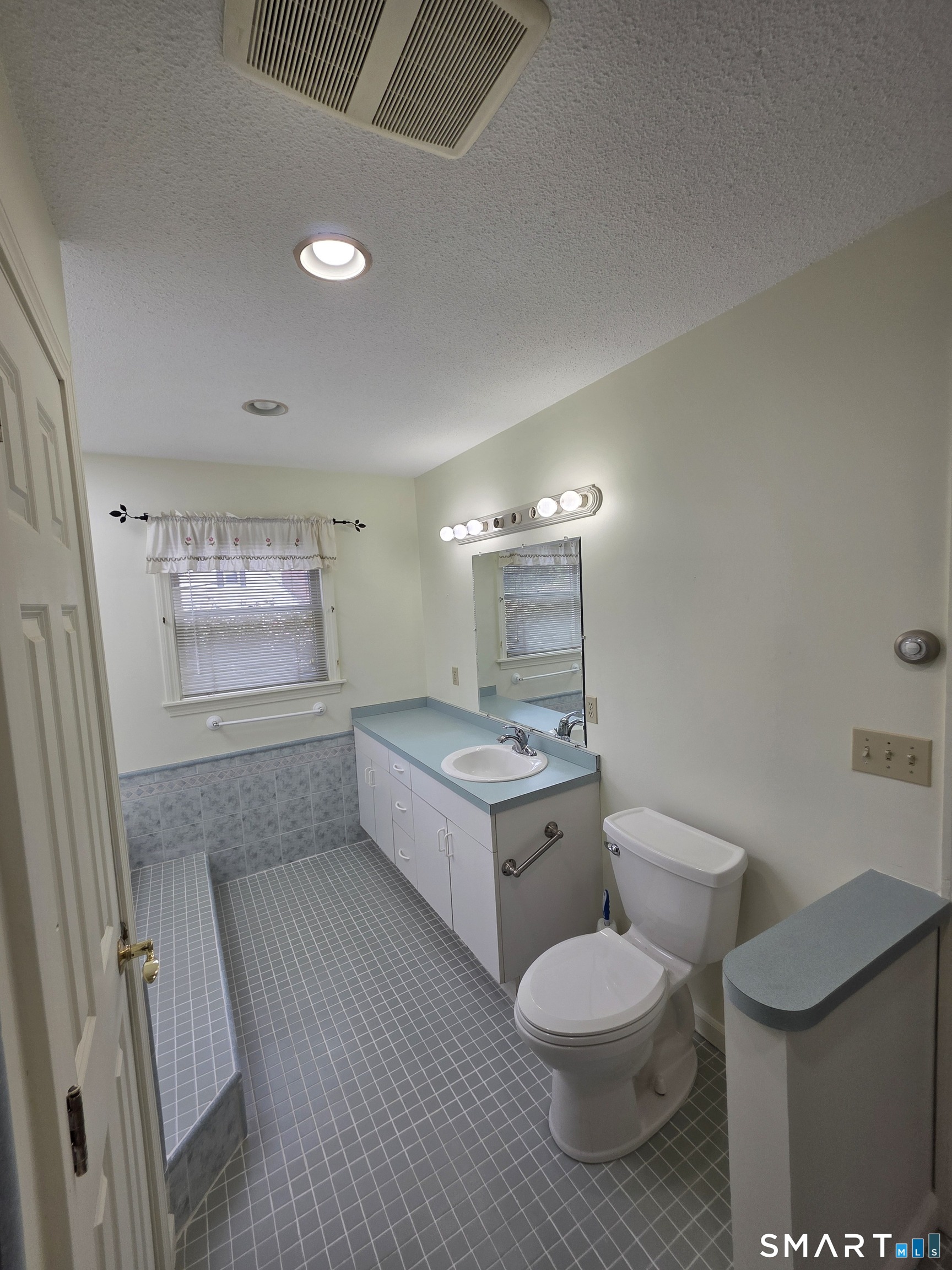 44 Steele Street New Britain, CT 06052 - Photo 16 of 27 a bathroom with a toilet sink a mirror and shower