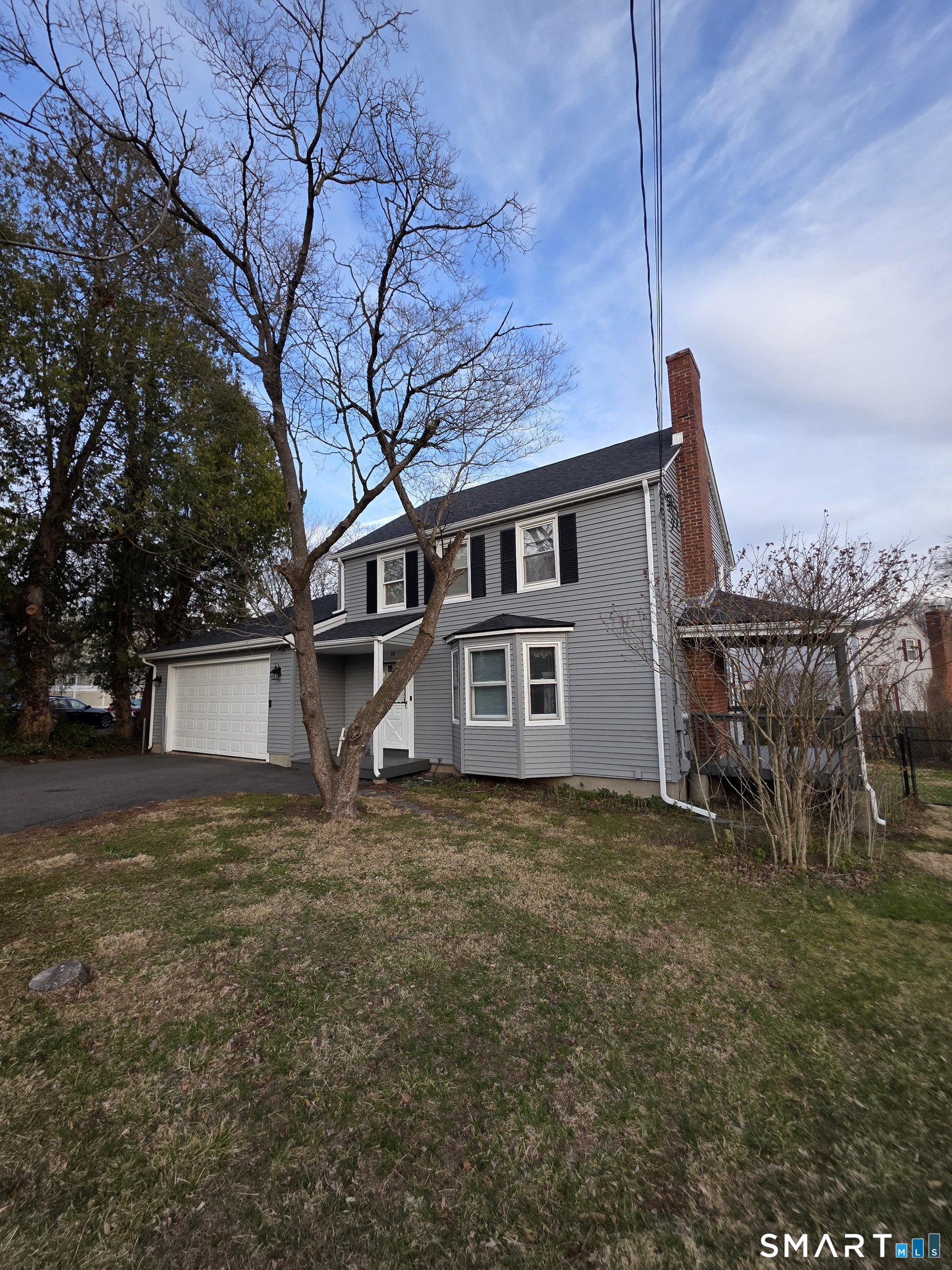 44 Steele Street New Britain, CT 06052 - Photo 4 of 27 a house that has a tree in front of it