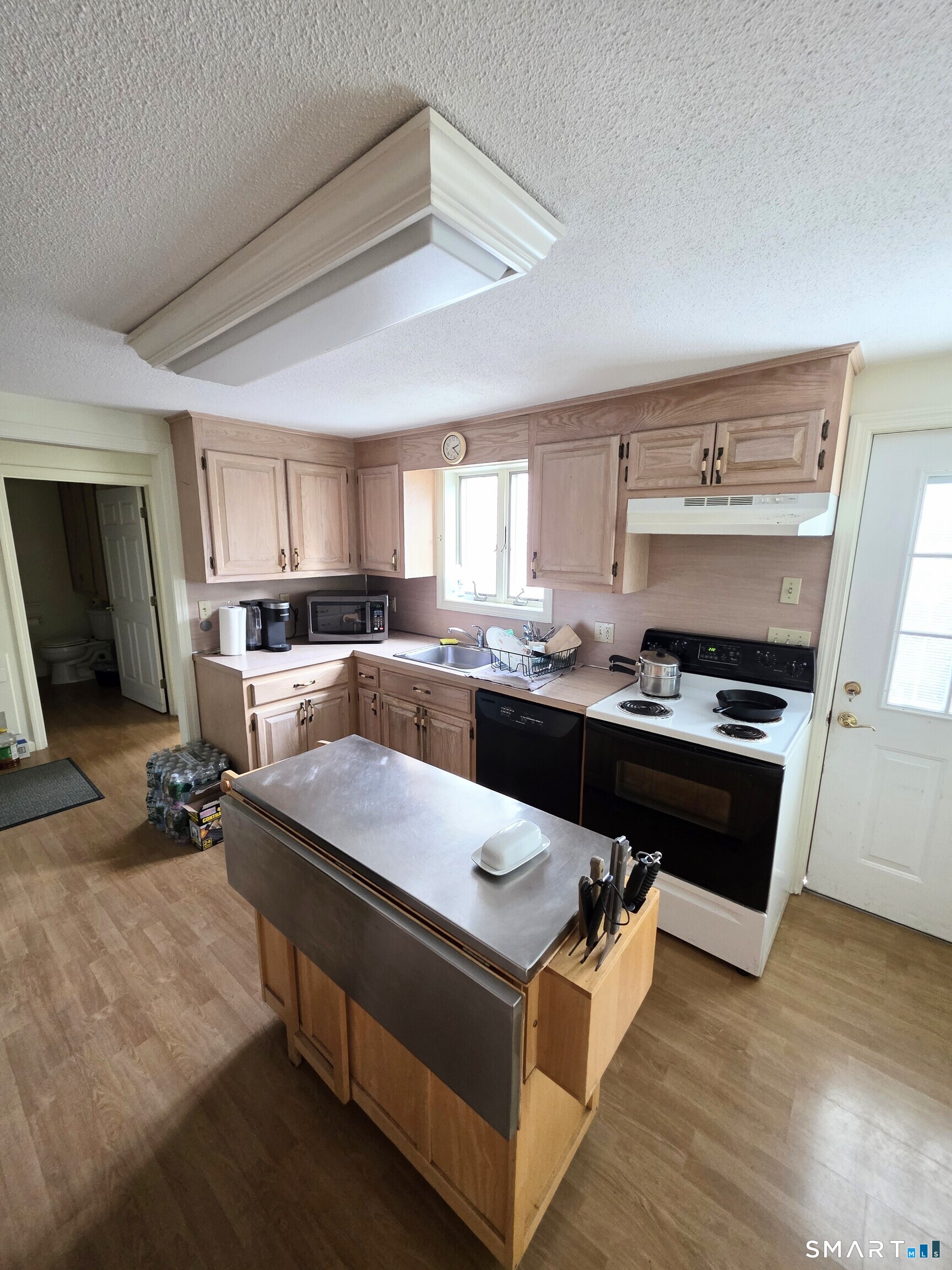 44 Steele Street New Britain, CT 06052 - Photo 6 of 27 a kitchen with a stove a sink and a refrigerator