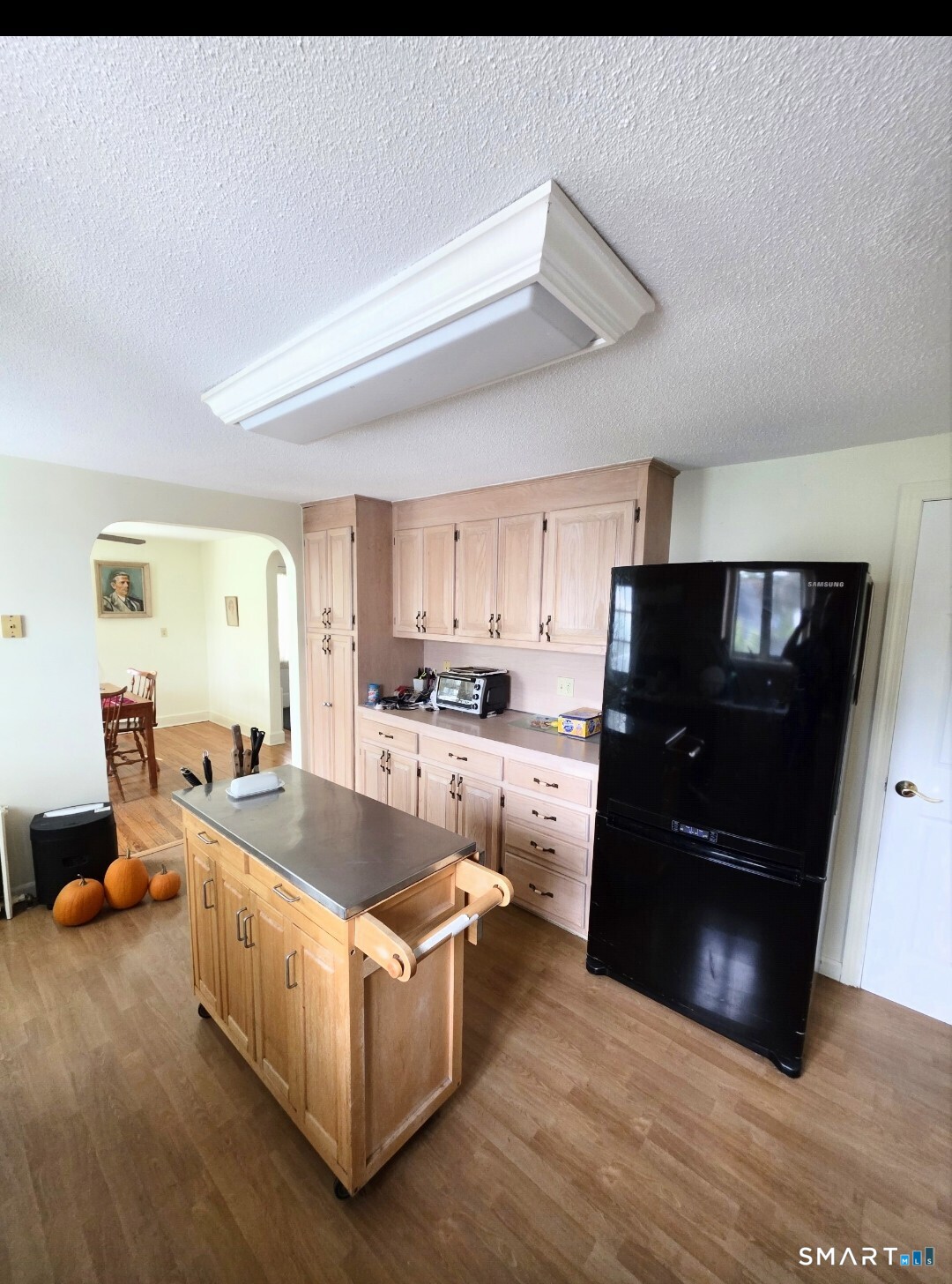 44 Steele Street New Britain, CT 06052 - Photo 7 of 27 a living room with stainless steel appliances kitchen island granite countertop a refrigerator a stove and a sink with wooden floor