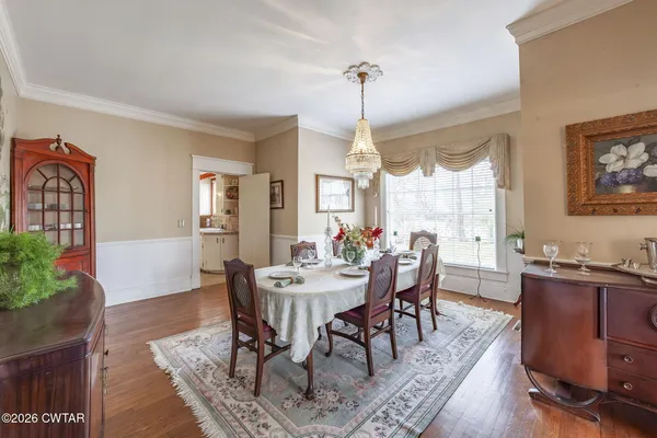 a kitchen with granite countertop a sink appliances cabinets and a large window