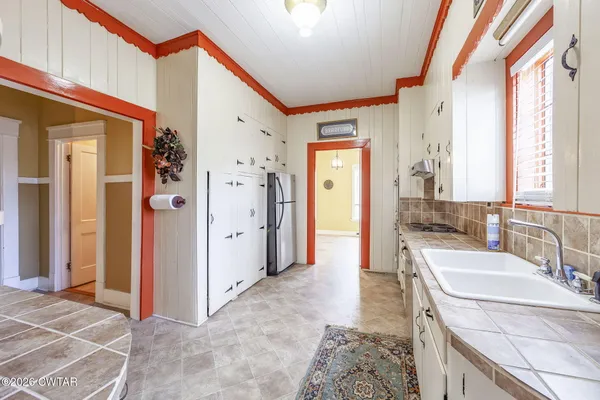 a white bath tub sitting next to a white toilet