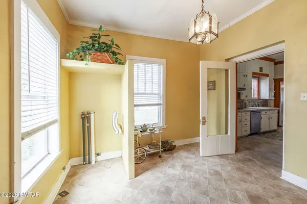 a living room with a bed furniture and a window