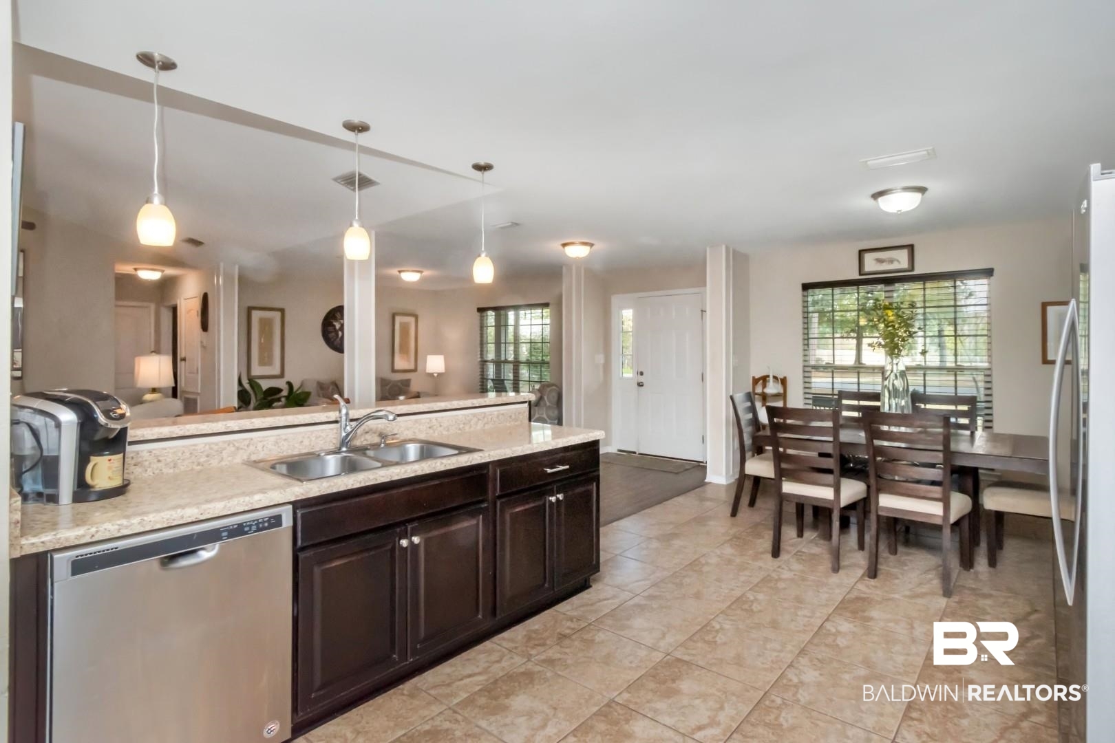 11528 Mocking Bird Lane Fairhope, AL 36532 - Photo 44 of 45 Kitchen with stainless steel appliances, light countertops, dark wood finish cabinetry, decorative light fixtures, and open floor plan