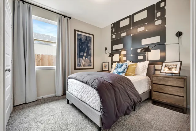 a bedroom with a bed and a mirror on the dresser