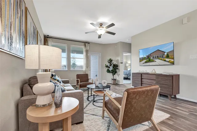a living room with furniture a chandelier and a fireplace