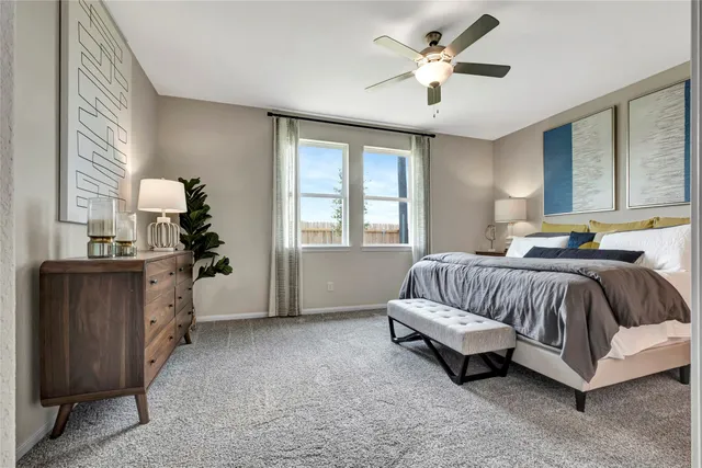 a spacious bedroom with a bed and a chandelier