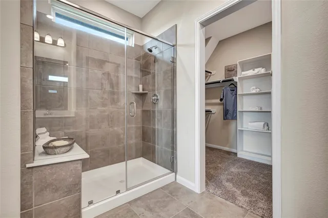 a bathroom with a glass shower door