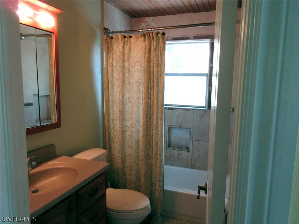 18415 Miller Road Fort Myers, FL 33967 - Photo 11 of 21 a bathroom with a sink a toilet a shower and a mirror