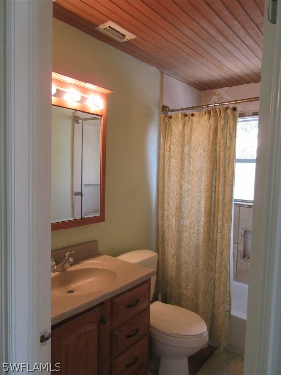 18415 Miller Road Fort Myers, FL 33967 - Photo 12 of 21 a bathroom with a granite countertop toilet a sink and a shower