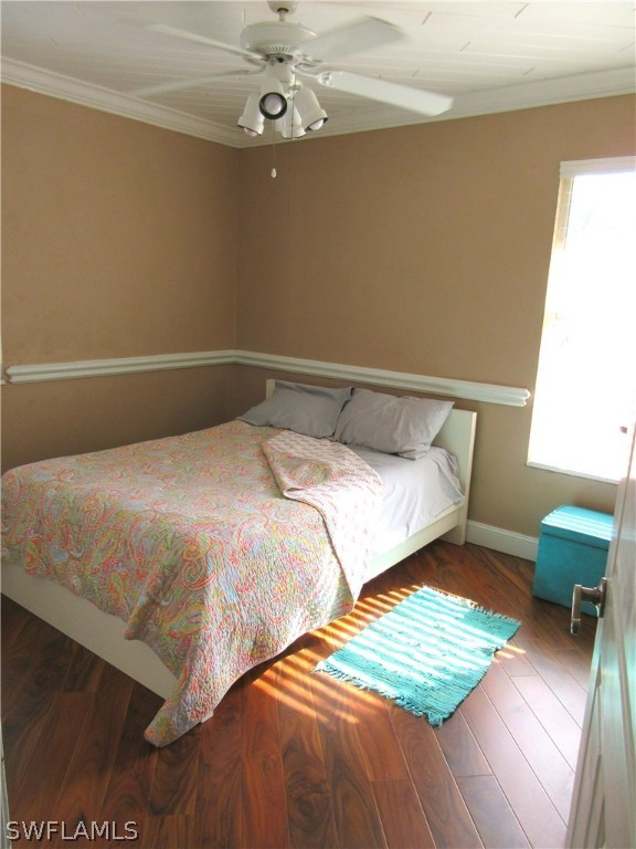 18415 Miller Road Fort Myers, FL 33967 - Photo 13 of 21 a bedroom with a bed and a chandelier
