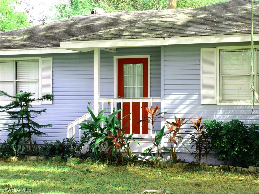 18415 Miller Road Fort Myers, FL 33967 - Photo 2 of 21 a front view of a house with garden
