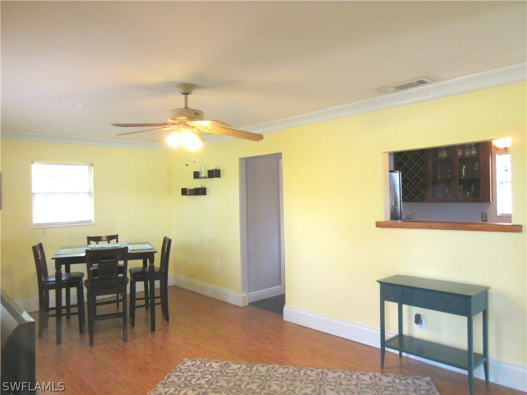18415 Miller Road Fort Myers, FL 33967 - Photo 3 of 21 a dining room with a wooden table and chairs