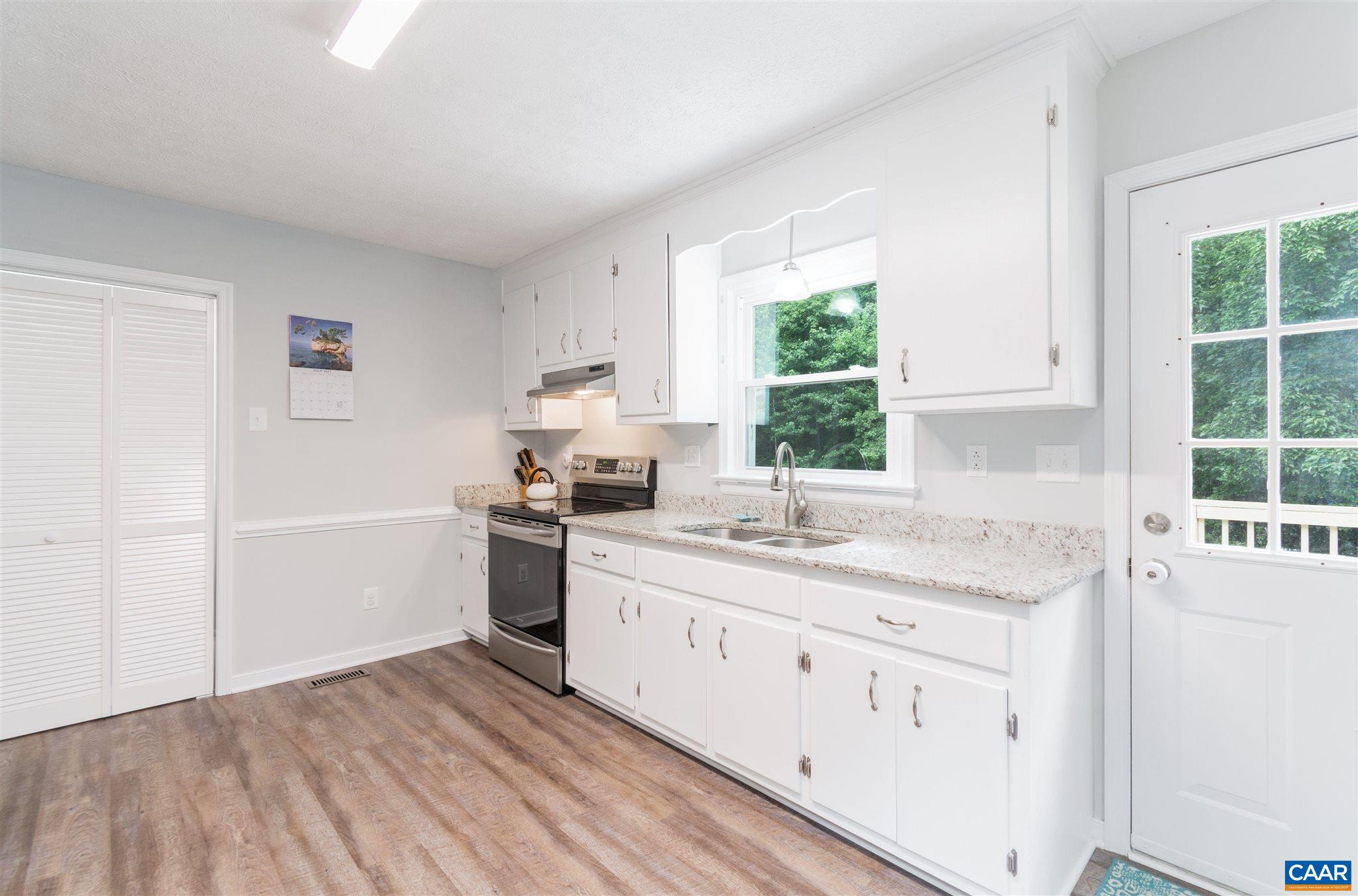 383 Broad St Road Kents Store, VA 23084 - Photo 8 of 22 a kitchen with a sink cabinets appliances and a window