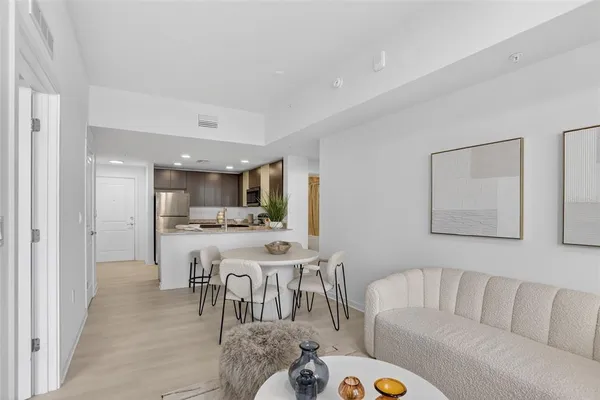 a living room with furniture and view of kitchen