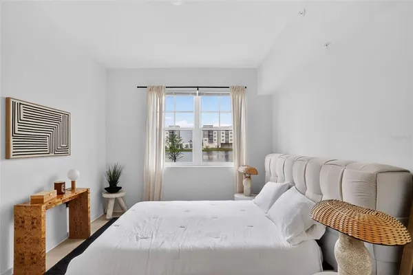 a bedroom with furniture and a window