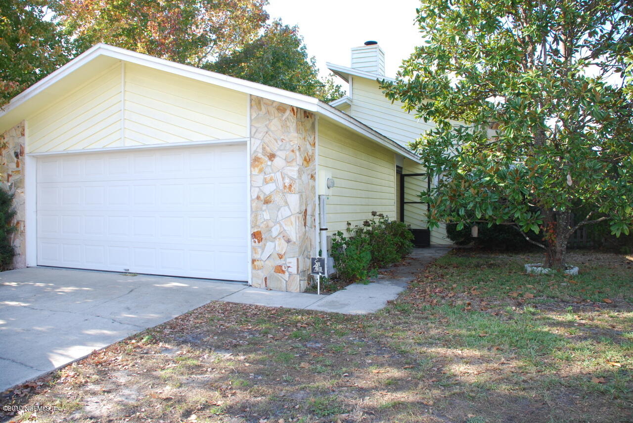 a view of a wooden house with a yard