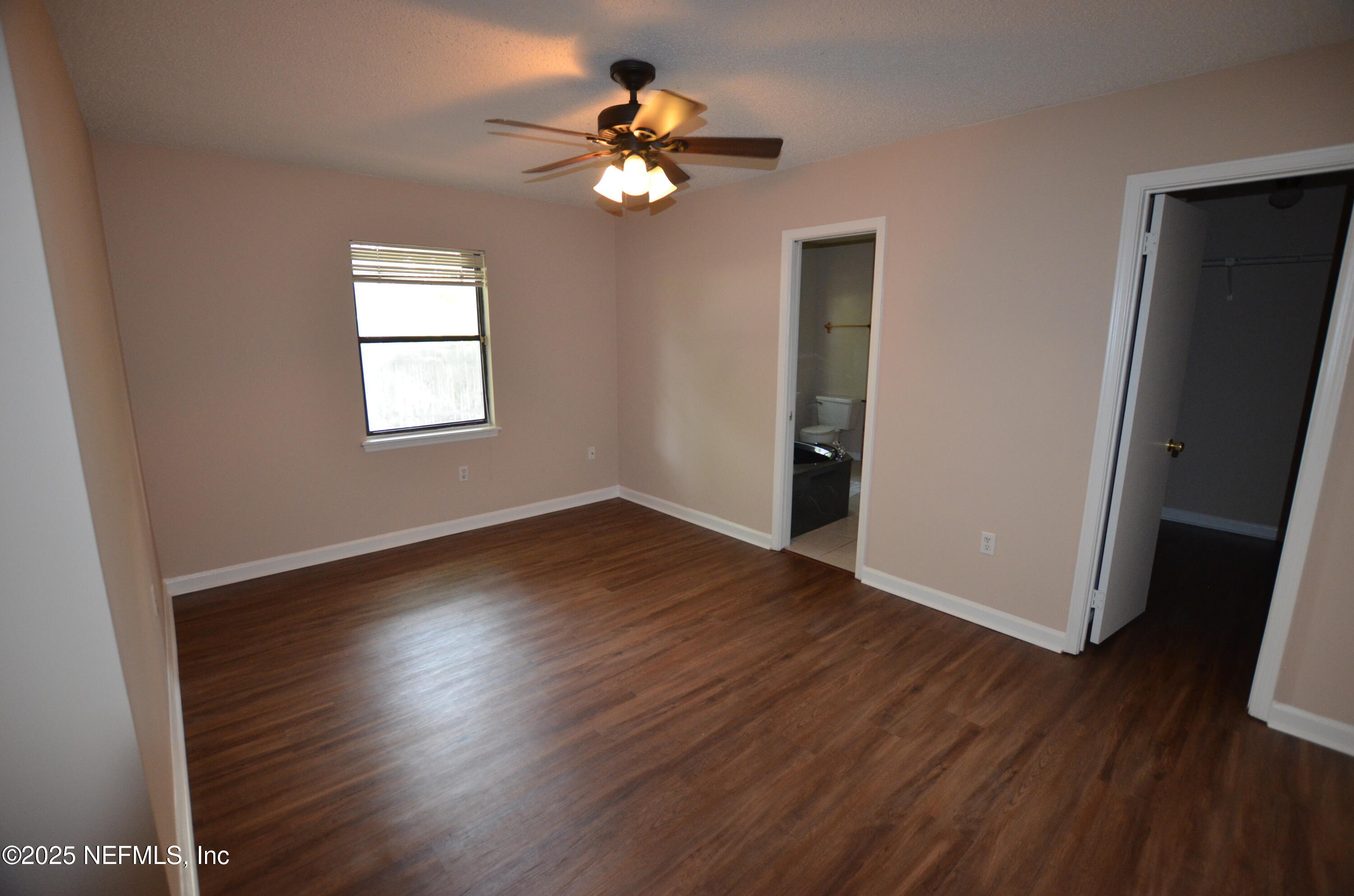 362 Filmore Drive Jacksonville, FL 32225 - Photo 7 of 13 a view of an empty room with wooden floor and a window