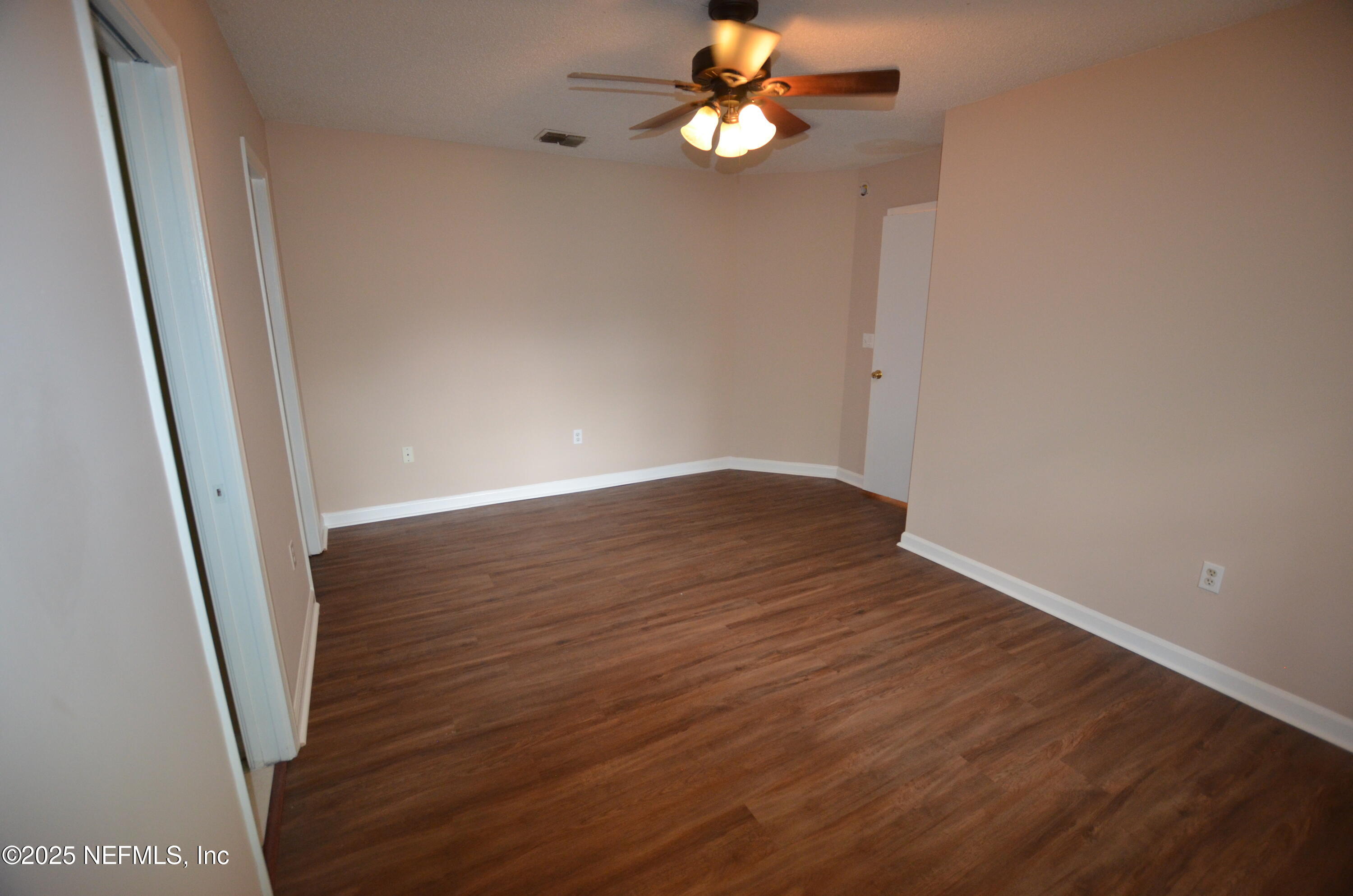 362 Filmore Drive Jacksonville, FL 32225 - Photo 8 of 13 an empty room with wooden floor and fan