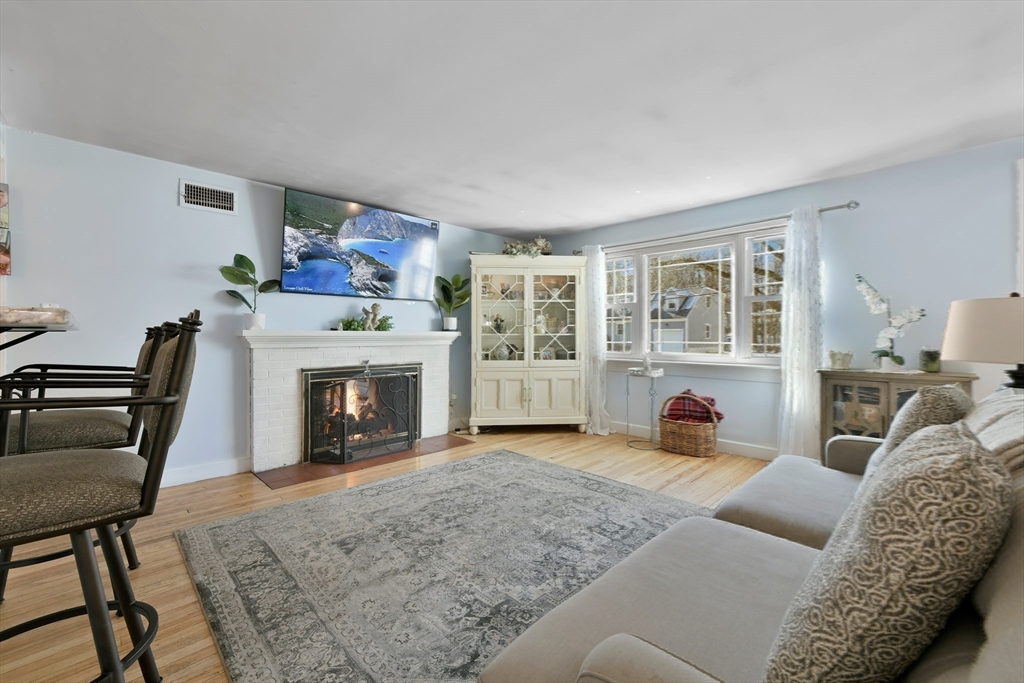 22 Stratford Road Natick, MA 01760 - Photo 12 of 41 a living room with furniture and a fireplace