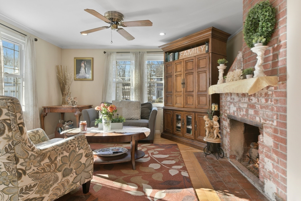 22 Stratford Road Natick, MA 01760 - Photo 18 of 41 a living room with furniture a fireplace and a table