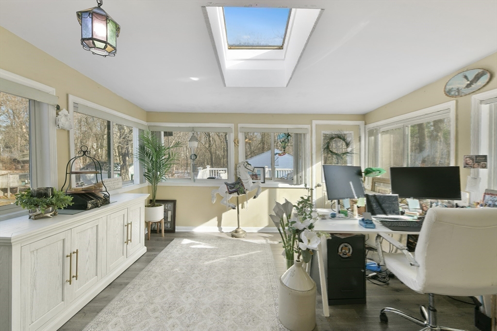 22 Stratford Road Natick, MA 01760 - Photo 19 of 41 a living room with furniture a large window and a chandelier