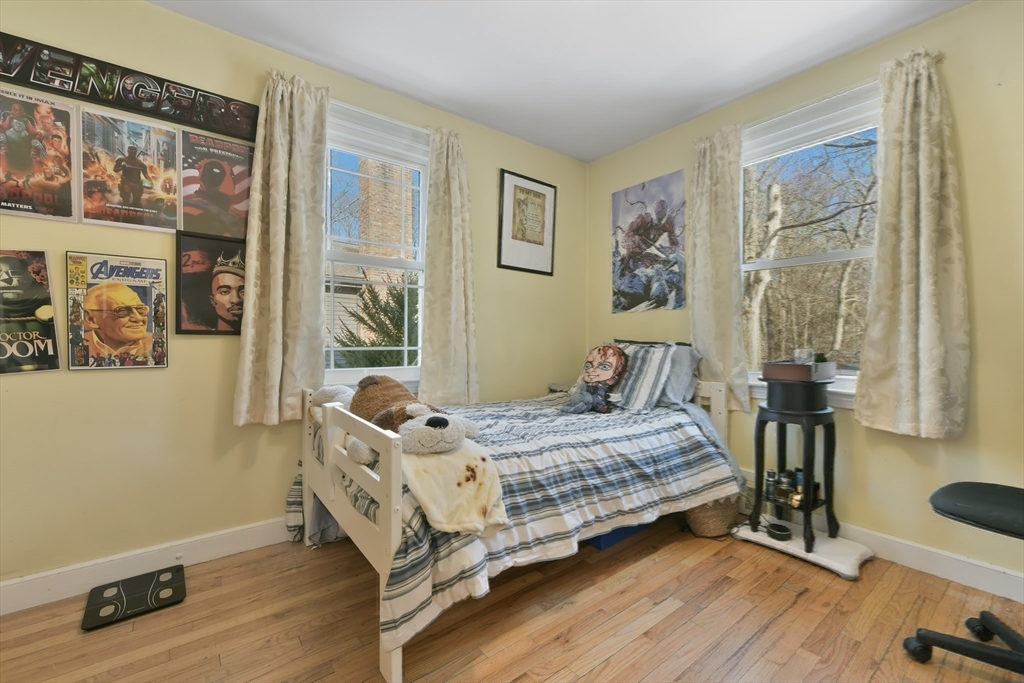 22 Stratford Road Natick, MA 01760 - Photo 22 of 41 a bedroom with a bed and wooden floor